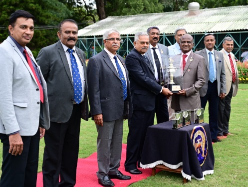 Mr.G.Venkatesh,Chairman & Senior Steward of Mysore Race Club ltd., Presenting,  ” The Mysore Race Club Anniversary Cup”  To the Winner – SHAMROCK Trophy received by –  Mr M Ravi